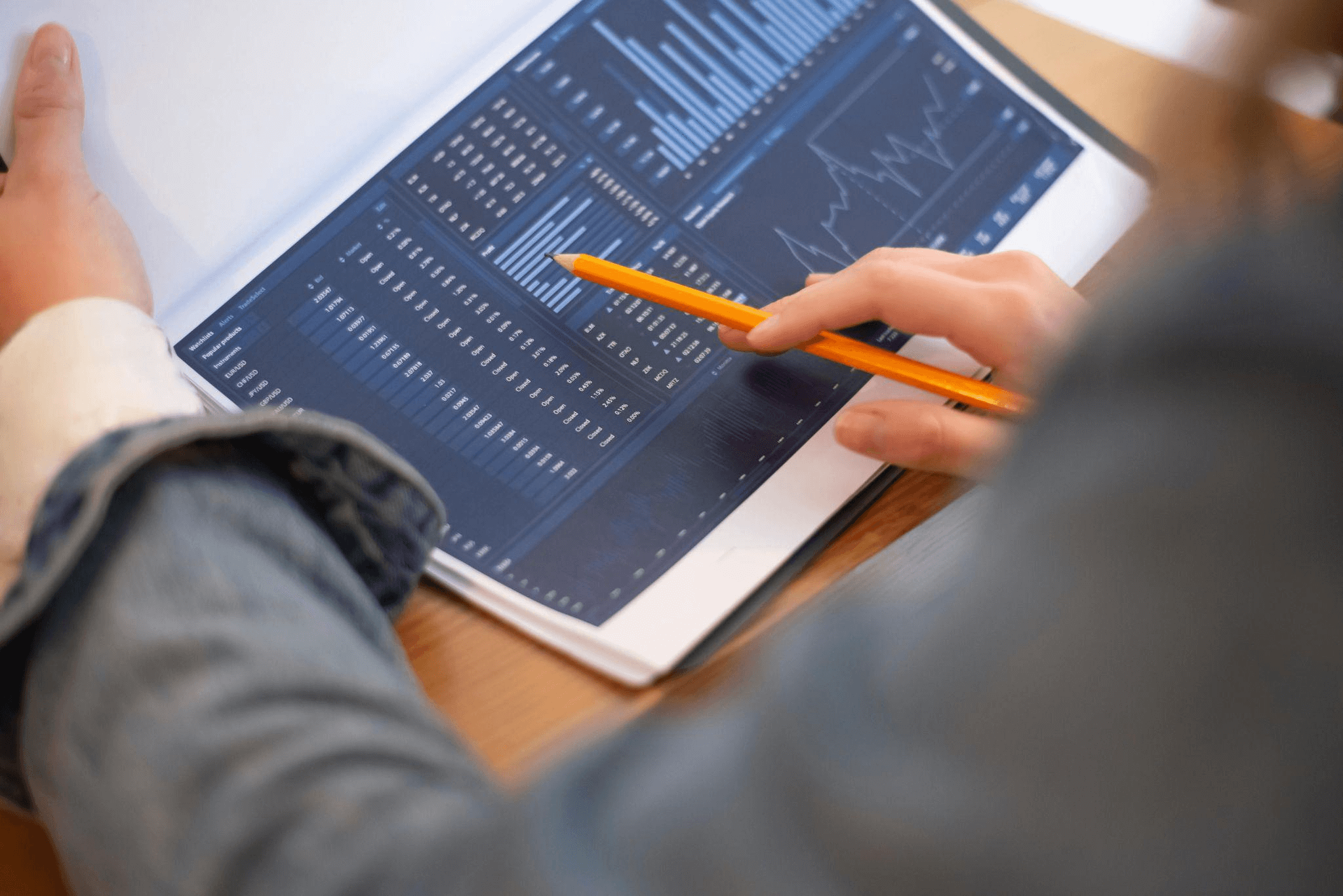 A person holding a business analytics report with charts and graphs, illustrating data-driven research techniques as part of an effective blog content strategy.