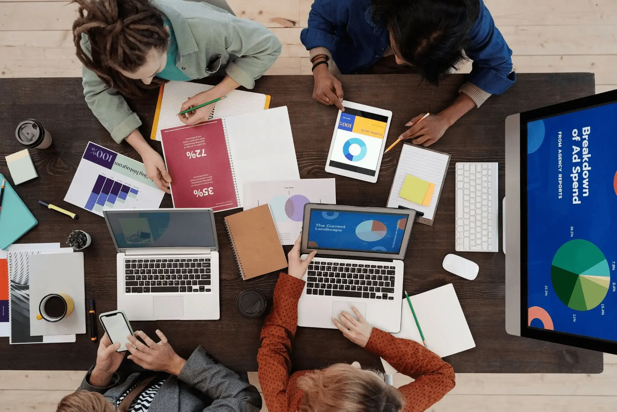 A group of professionals discussing charts and data, illustrating the strategic planning involved in a content marketing service.