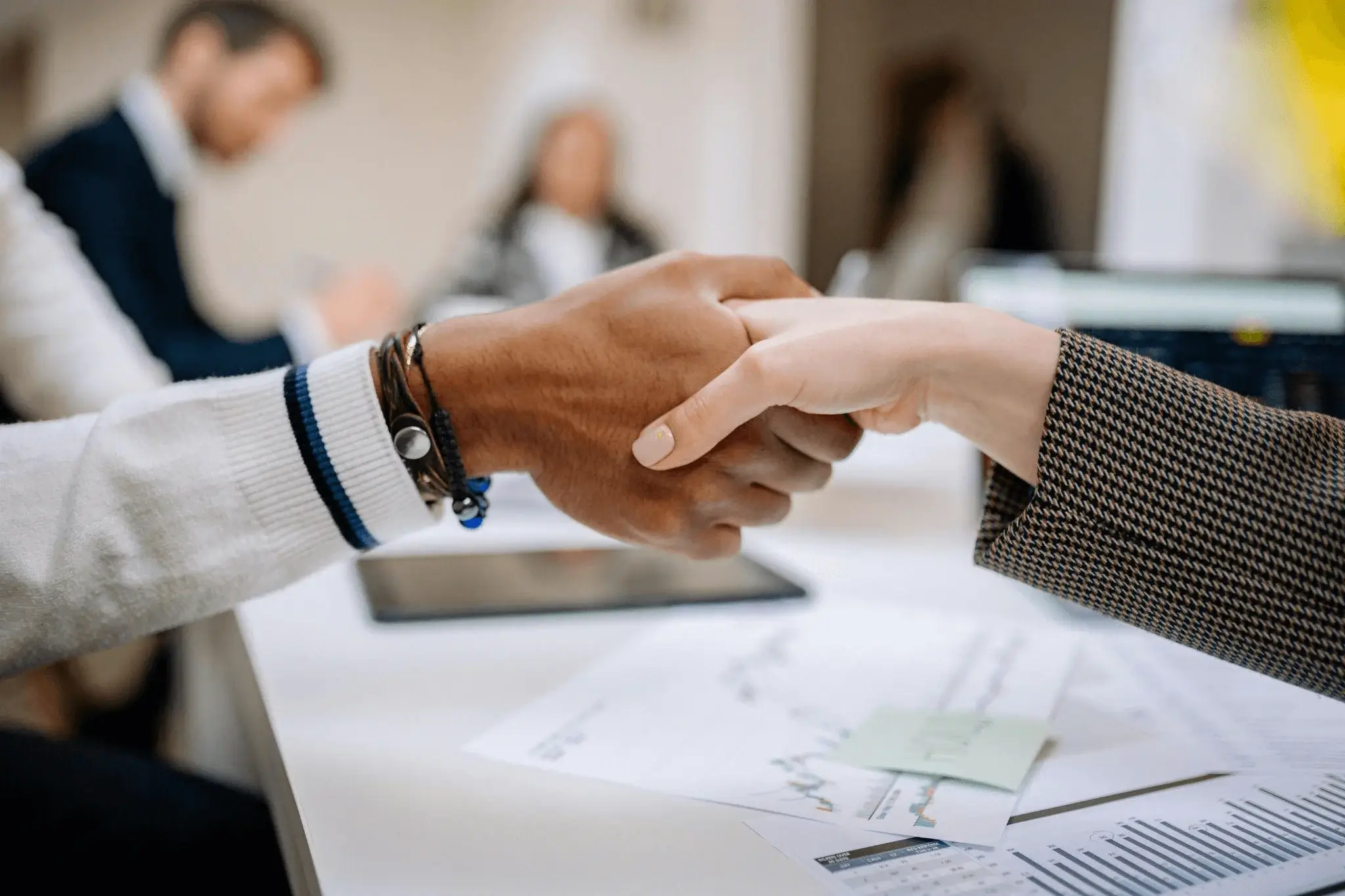 Close-up of a professional handshake symbolizing collaboration in a content marketing service partnership.