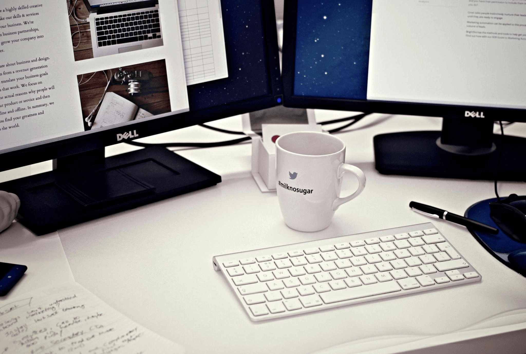 Clean workspace with computer monitors and a coffee mug, representing the setup for efficient blogging supported by a blog writing service.