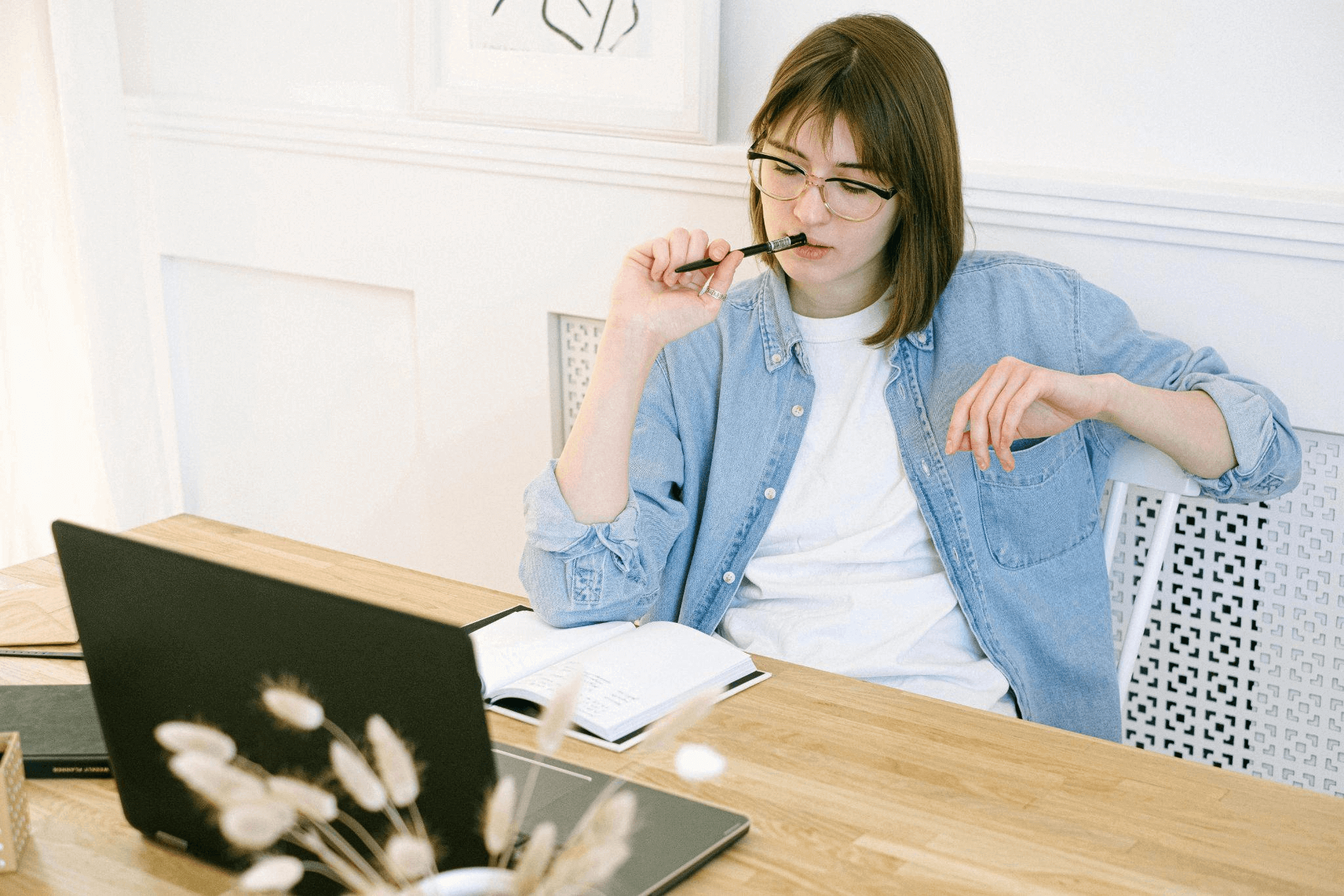 Woman working from home on her laptop, representing productivity and focus for a blog writing service.