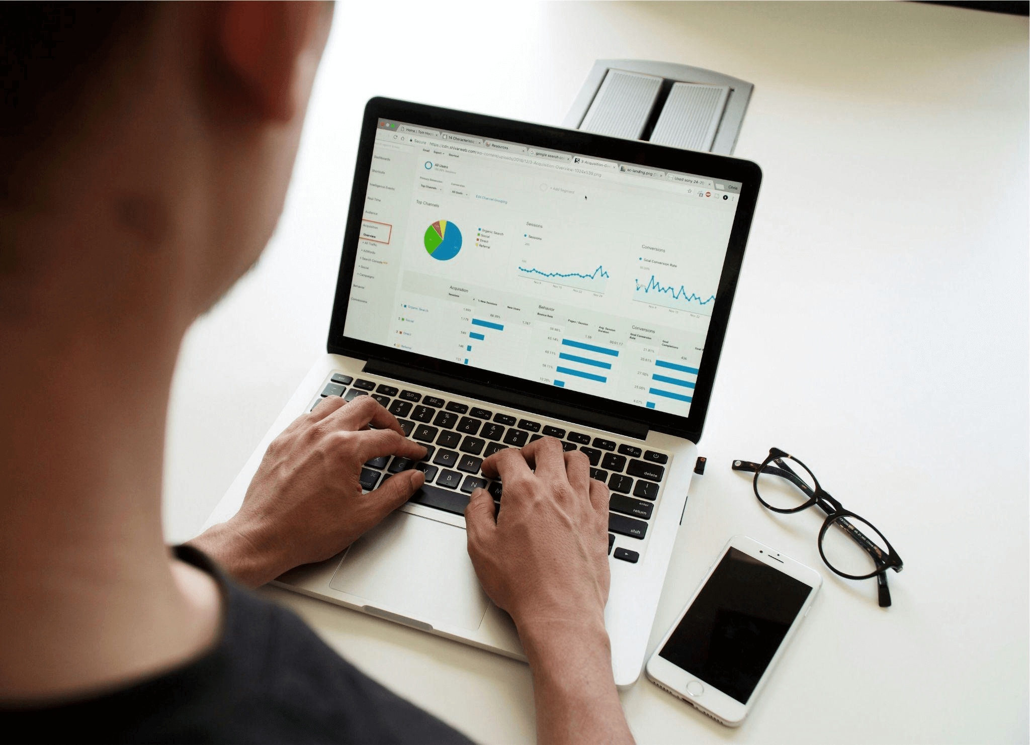Marketer creating content and analyzing data as part of a digital marketing agency's funnel optimization process.