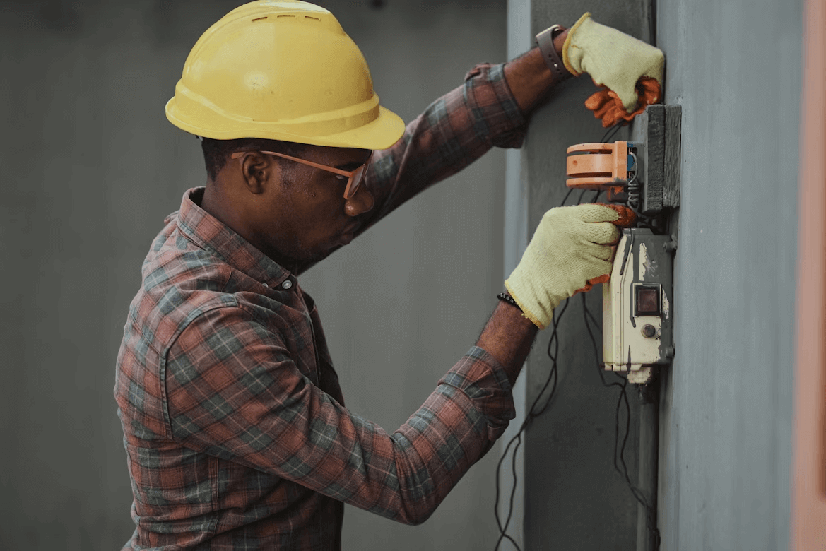 An electrician in safety gear at a work site, representing the importance of digital marketing for electricians in promoting their services professionally.