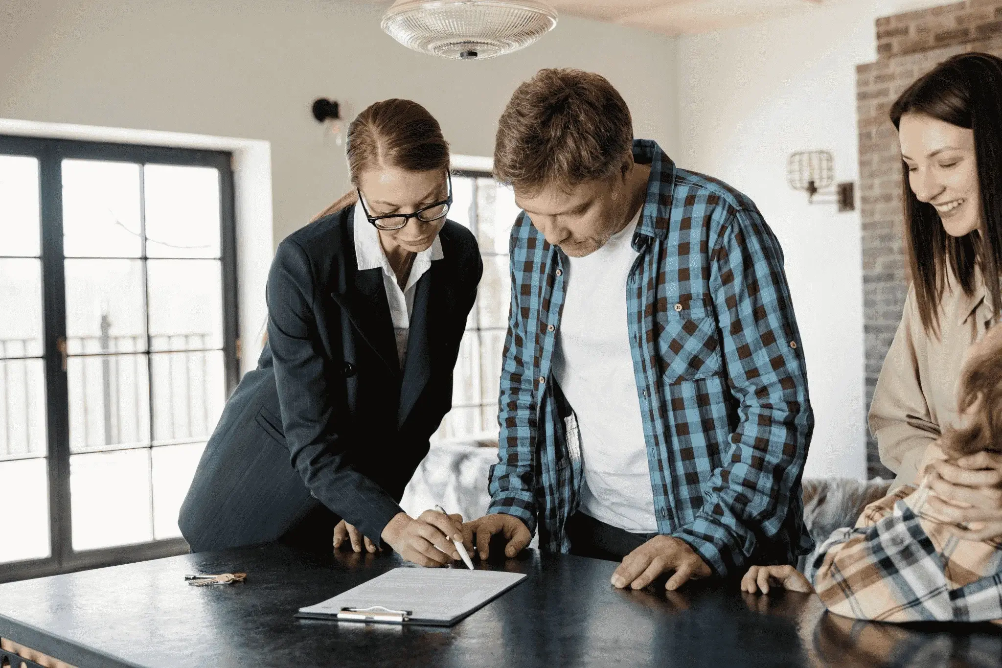 A real estate agent explaining a document to a client, highlighting the importance of clear communication in real estate SEO.