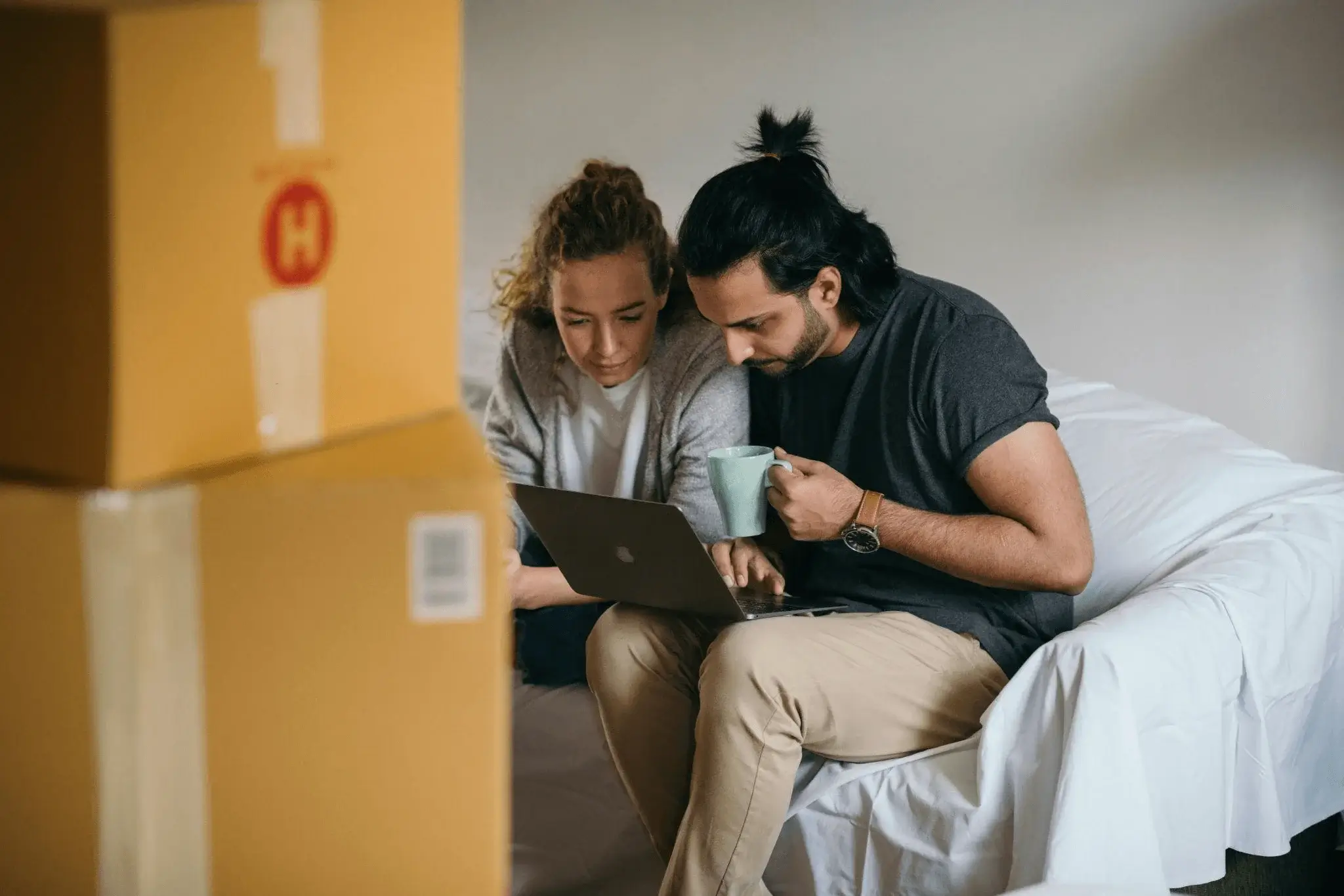 A couple browsing real estate listings on a laptop, illustrating how local SEO helps homebuyers find properties through real estate SEO.